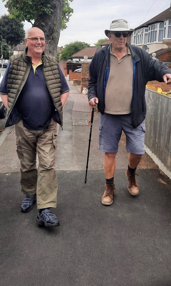 Bobby walking (with his walking pole) and his friend Alan.
