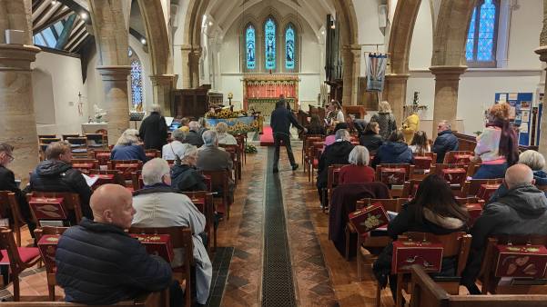 The packed church, looking towards the altar with Bobby's coffin in front of the congregation.