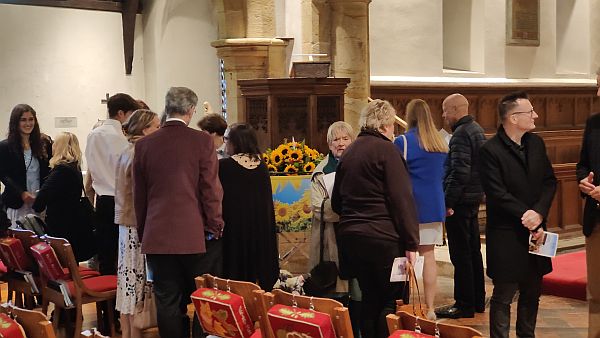 Guests taking a closer look at the coffin after the service.