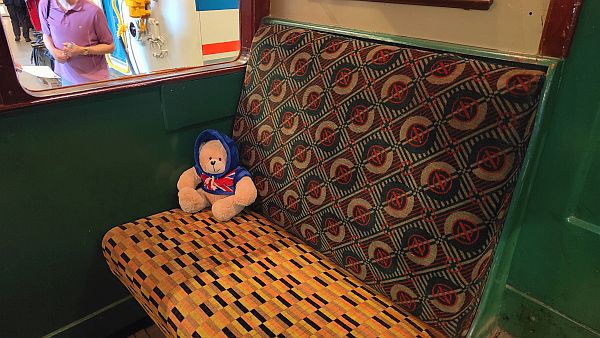 Charlie on a comfortable looking underground train seat.